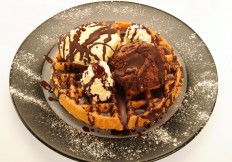 Waffle with 2 ice cream scoops and chocolate syrup
